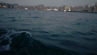 a body of water with a city in the background