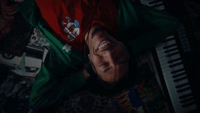a man laying on top of a floor next to a keyboard