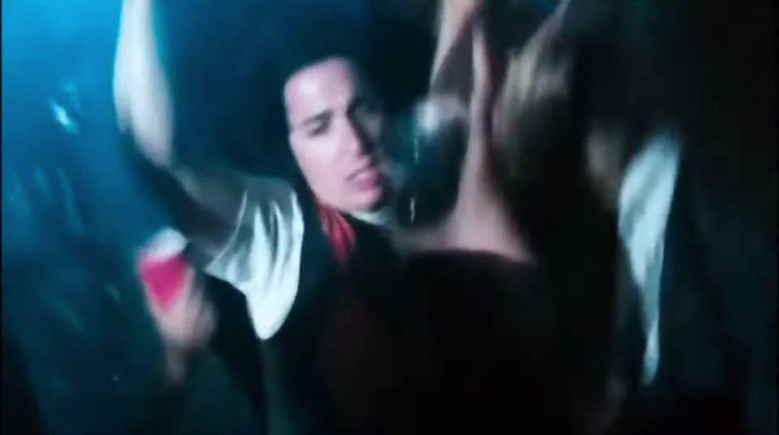 a man is dancing in a dark room