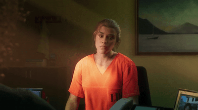 a woman in an orange shirt standing in a room