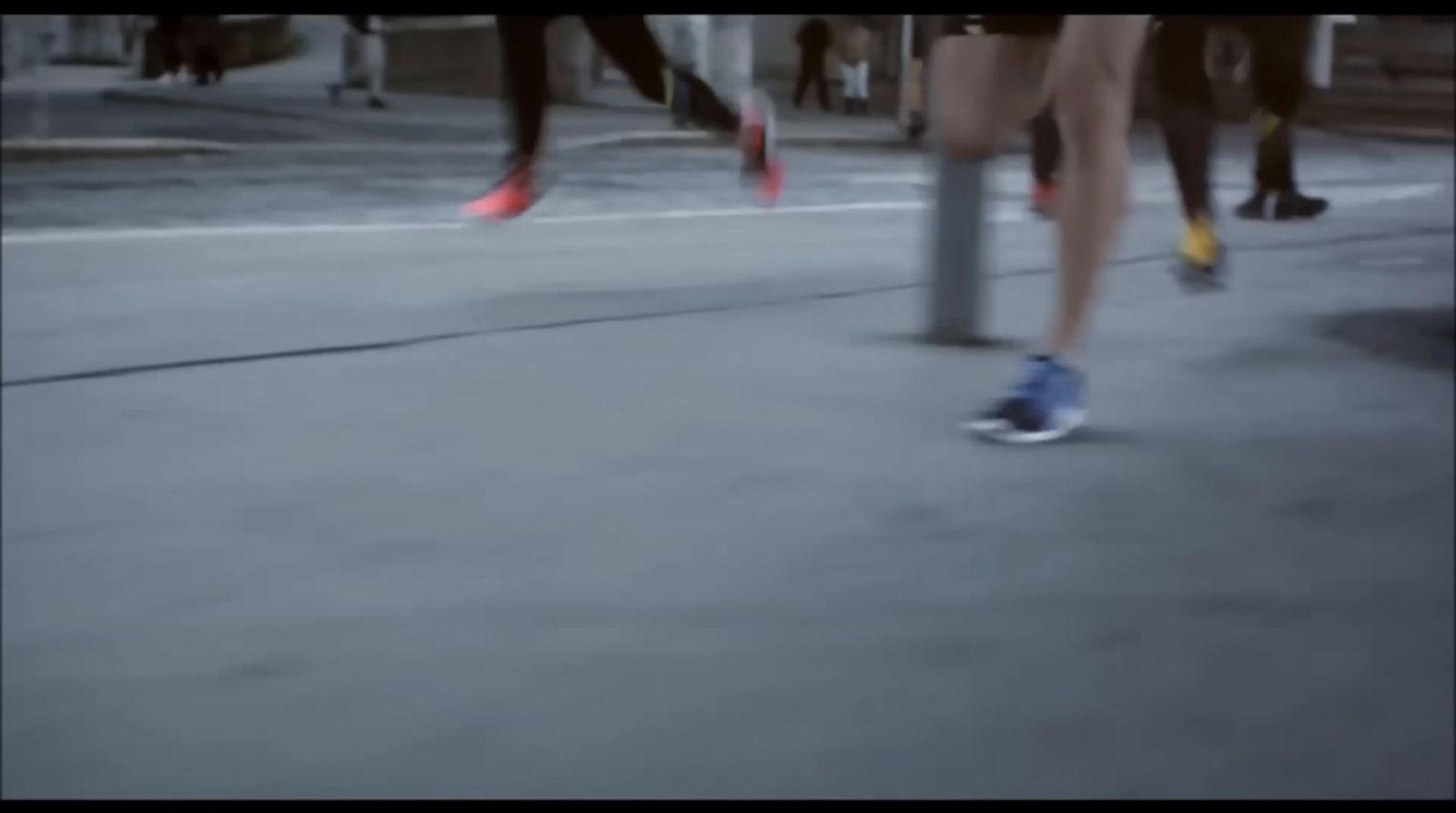 a group of people walking down a street next to each other
