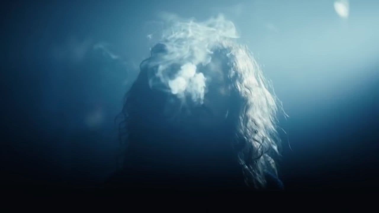 a blurry photo of a person with long hair