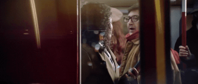 a man and a woman standing on a bus
