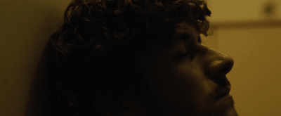 a close up of a person with curly hair