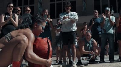 a group of people standing around a fire hydrant