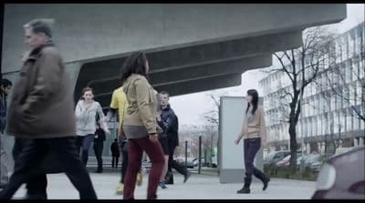 a group of people walking down a sidewalk