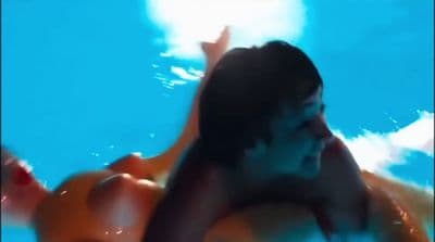 a man swimming in a pool with an inflatable raft