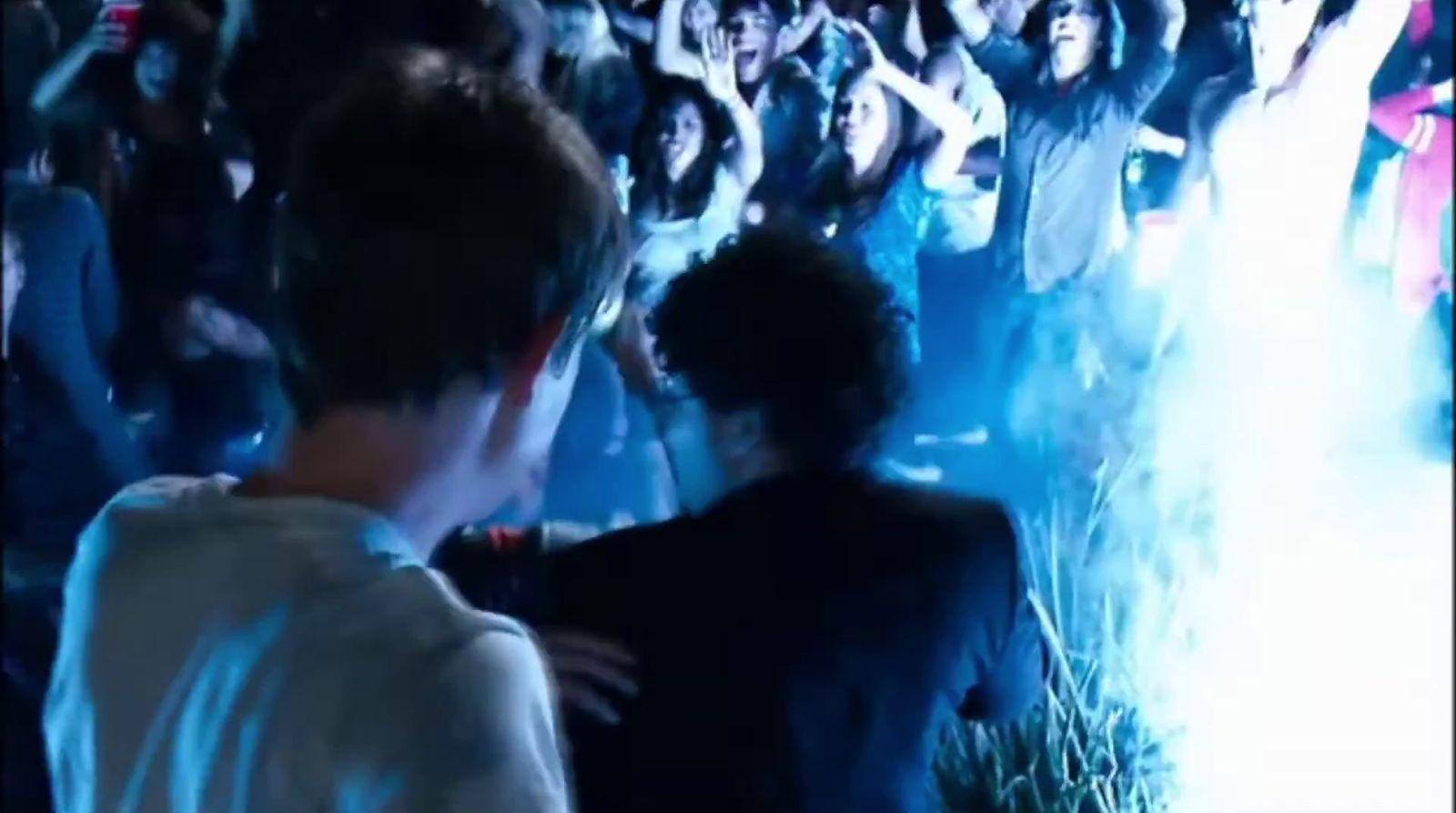 a crowd of people standing around a stage