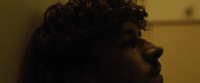 a close up of a person with curly hair