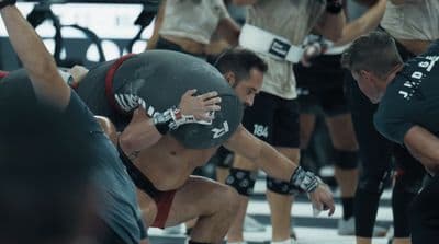 a group of men wrestling in a gym