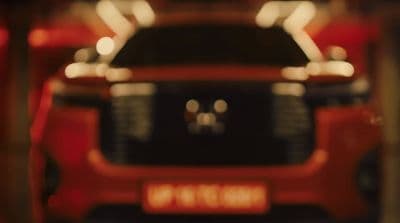 a close up of a red car in a garage