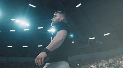 a man standing in front of a crowd in a stadium