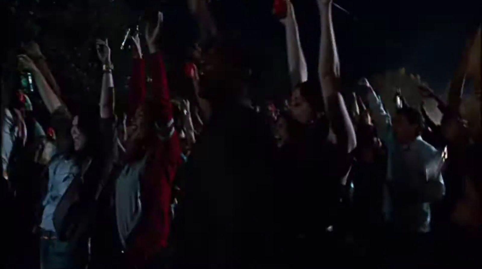 a group of people holding up their hands in the air