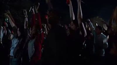 a group of people holding up their hands in the air