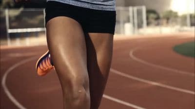 a close up of a person running on a track