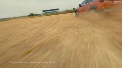 a red truck driving down a dirt road