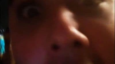 a close up of a person talking on a cell phone