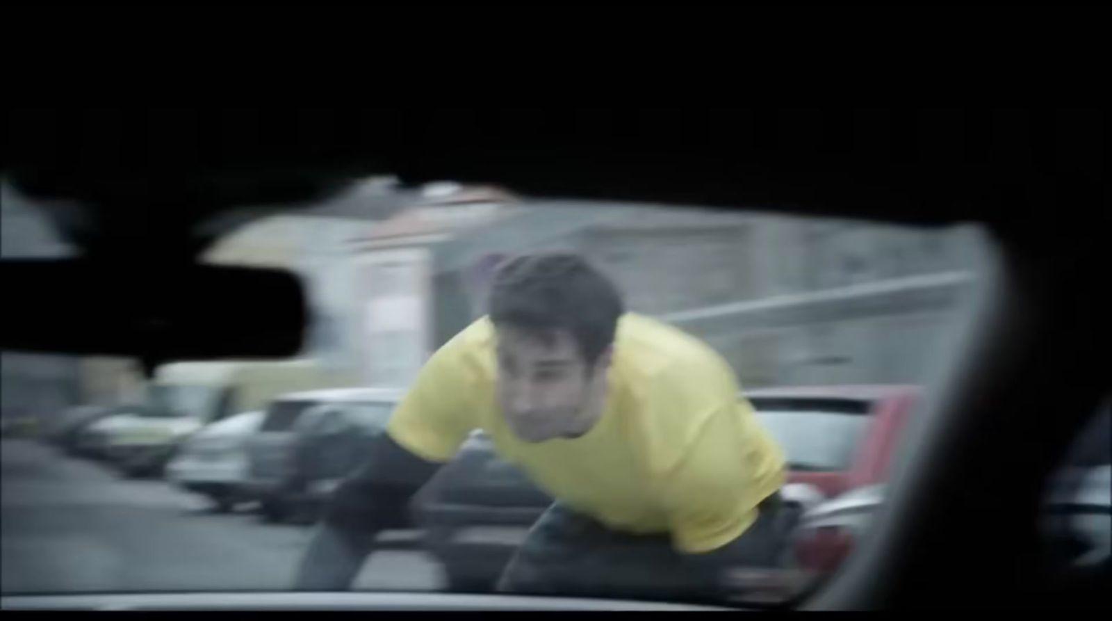a man riding on the back of a car