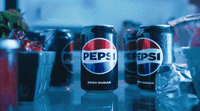 a group of cans of pepsi sitting on top of a table