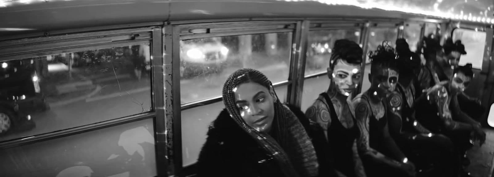 a black and white photo of a group of people on a bus