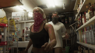 a man and a woman wearing masks in a store