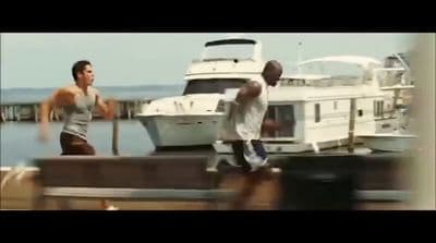 a couple of men standing next to a boat