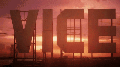 a large sign that is in front of a sunset