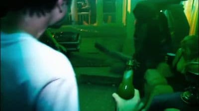 a man holding a bottle of beer in his hand