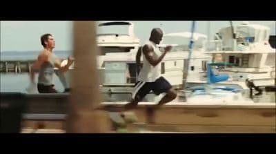 a man running on a dock next to a boat