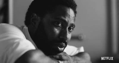 a black and white photo of a man with a beard