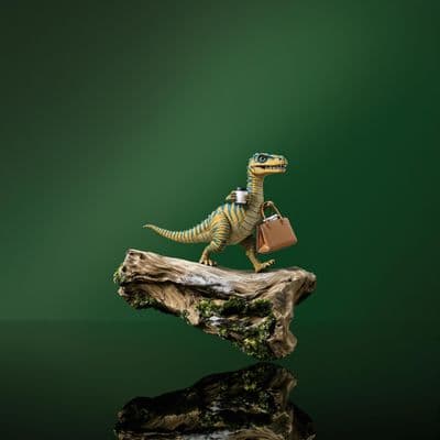 a toy dinosaur carrying a bag on top of a log