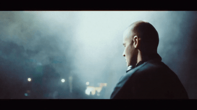 a man standing in a dark room with fog