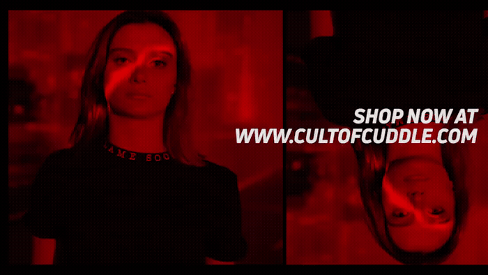 a woman standing in front of a red light