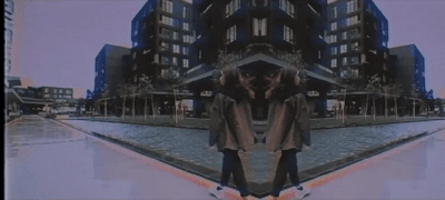 a couple of people standing in front of a building