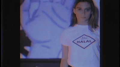 a woman standing in front of a television screen