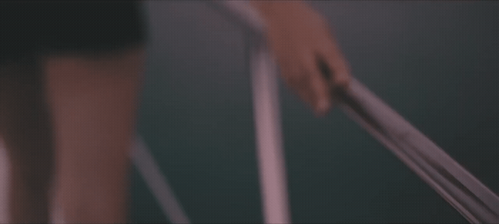 a blurry photo of a person holding a pair of scissors