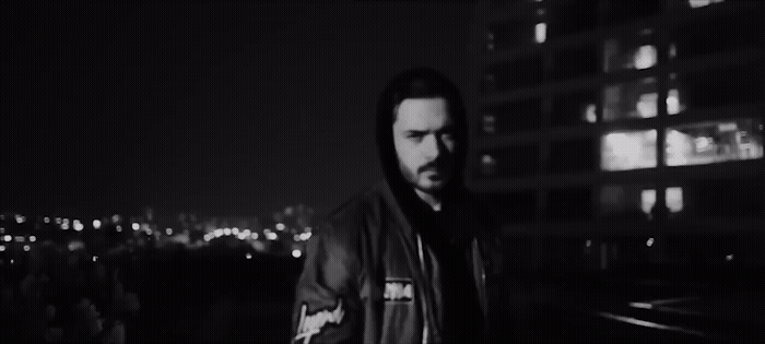 a man standing in front of a building at night