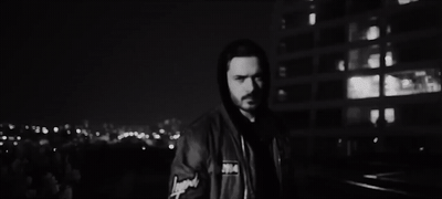 a man standing in front of a building at night