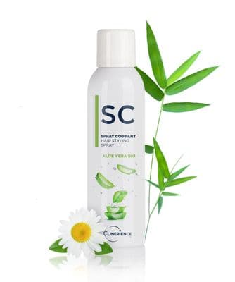 a bottle of shampoo next to a flower