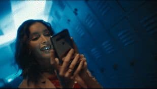 a woman holding a cell phone up to her face