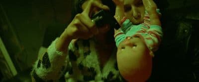 a woman holding a baby in her arms