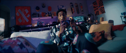 a man standing in a living room holding a camera