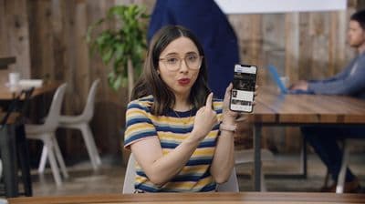 a woman holding up a cell phone in front of her face