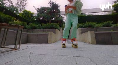 a man riding a skateboard down a sidewalk