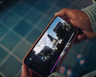 a person holding a cell phone in their hand