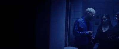 a man and a woman standing in a dark room