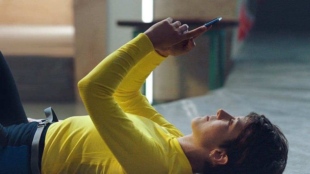 a man laying on the ground using a cell phone