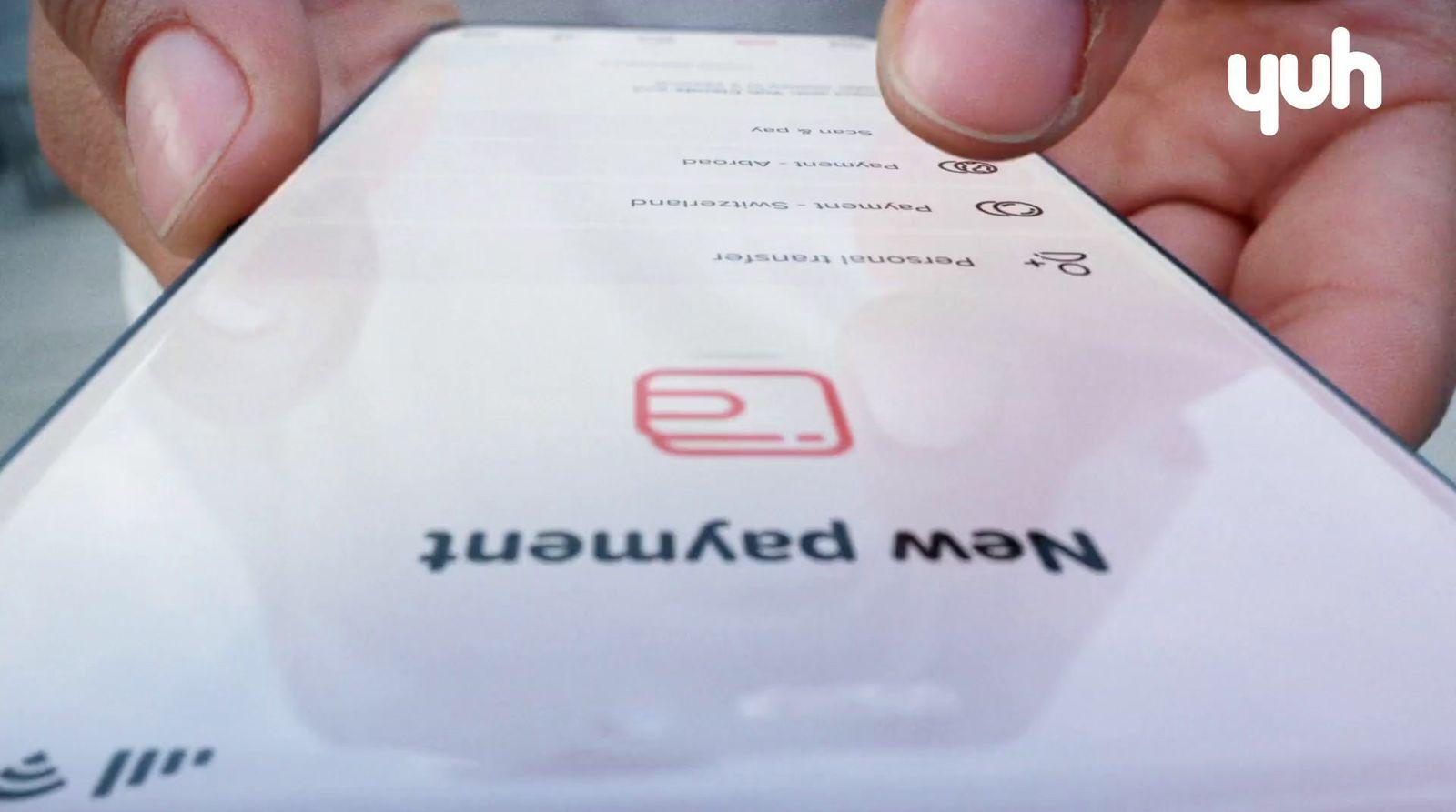 a close up of a person holding a paper with a logo on it
