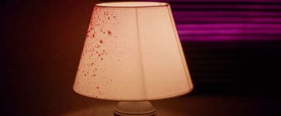 a lamp that is on a table in a room