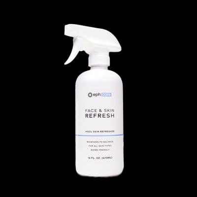 a bottle of face and skin refresh on a black background